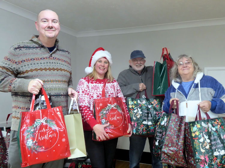 Norwich church volunteers pack bags of kindness